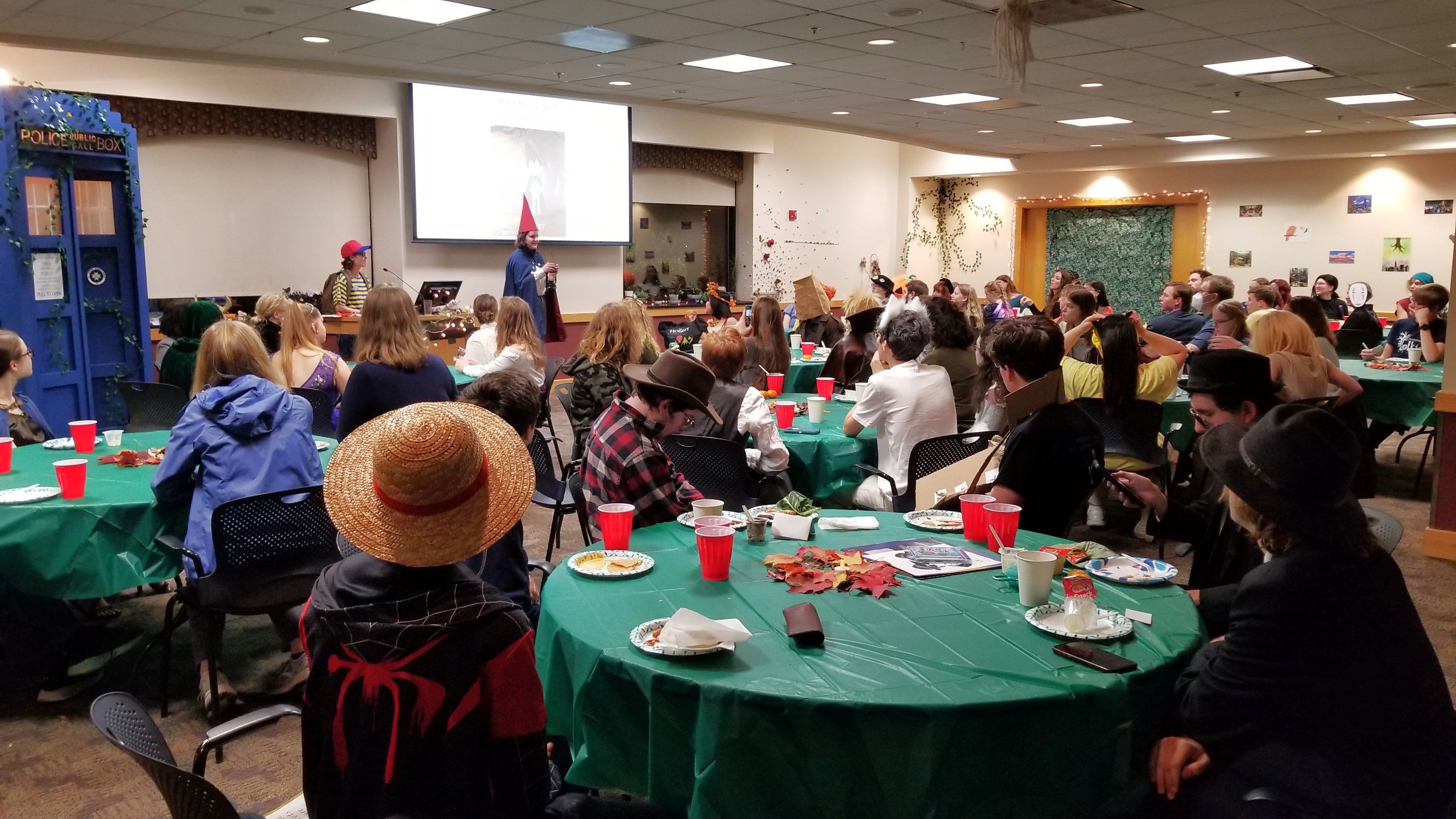 People in a large room wearing costumes