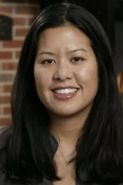 A dark-haired Thai woman smiles