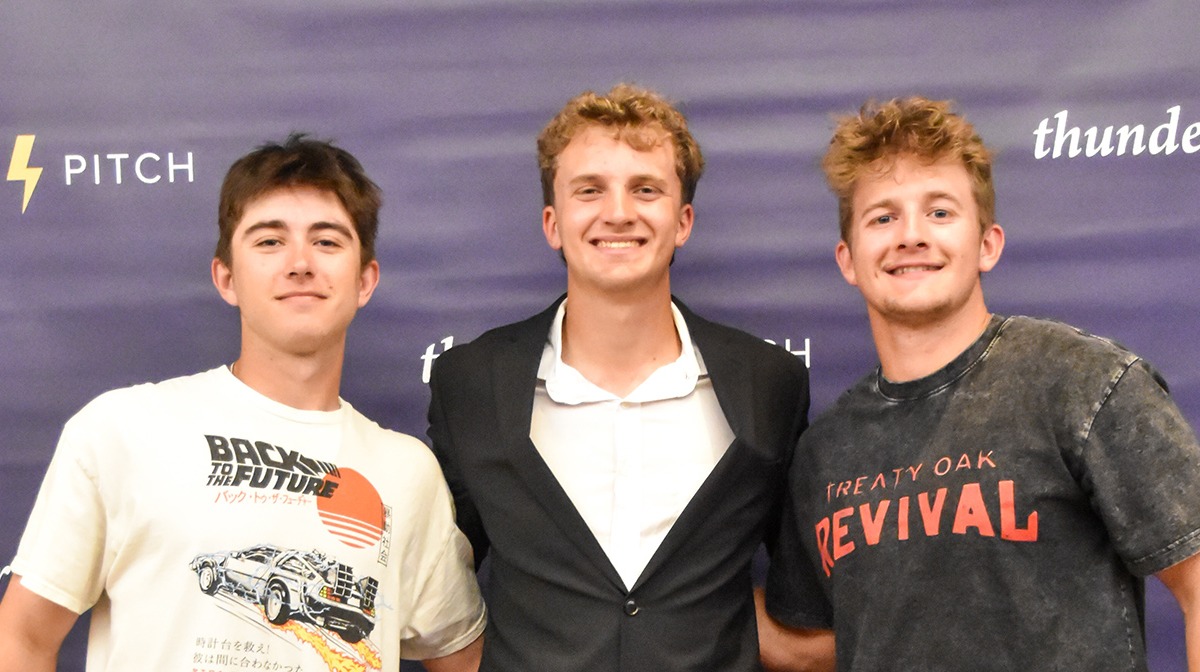 three students in front of TP background
