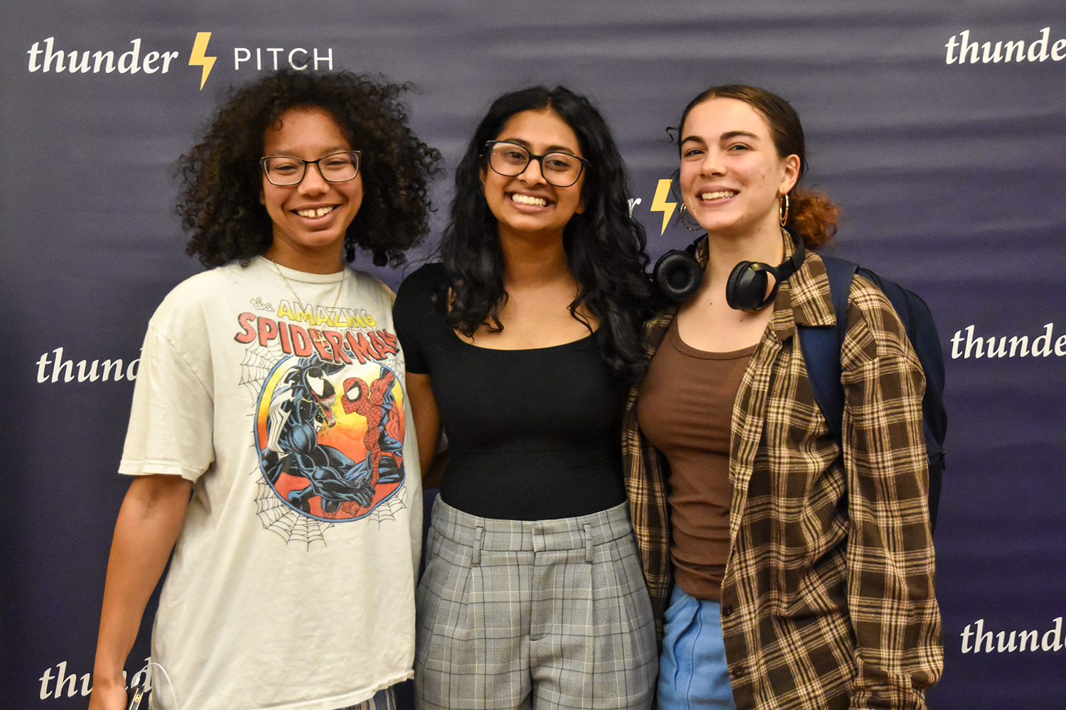 three students in front of TP background