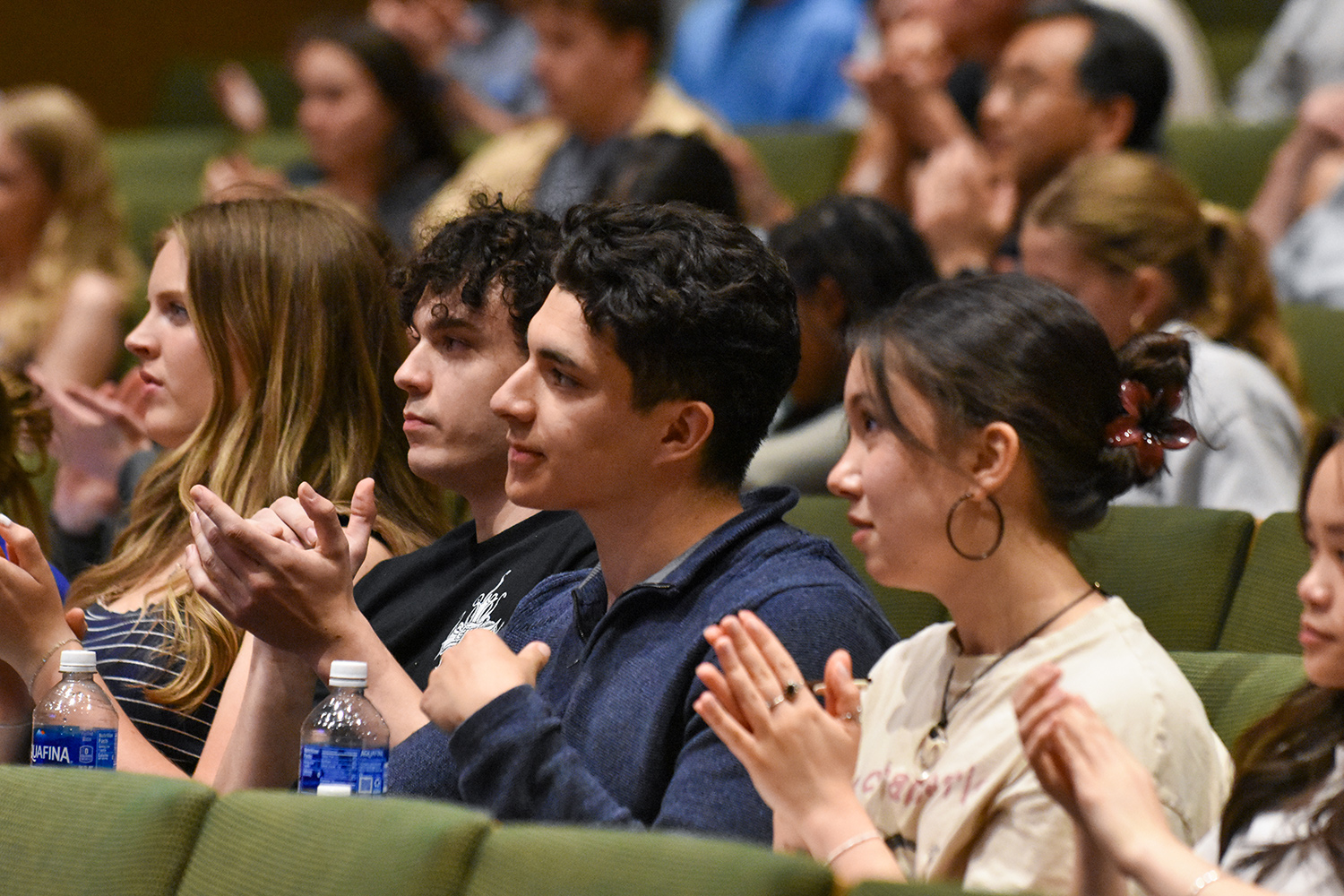 students in audience clapping