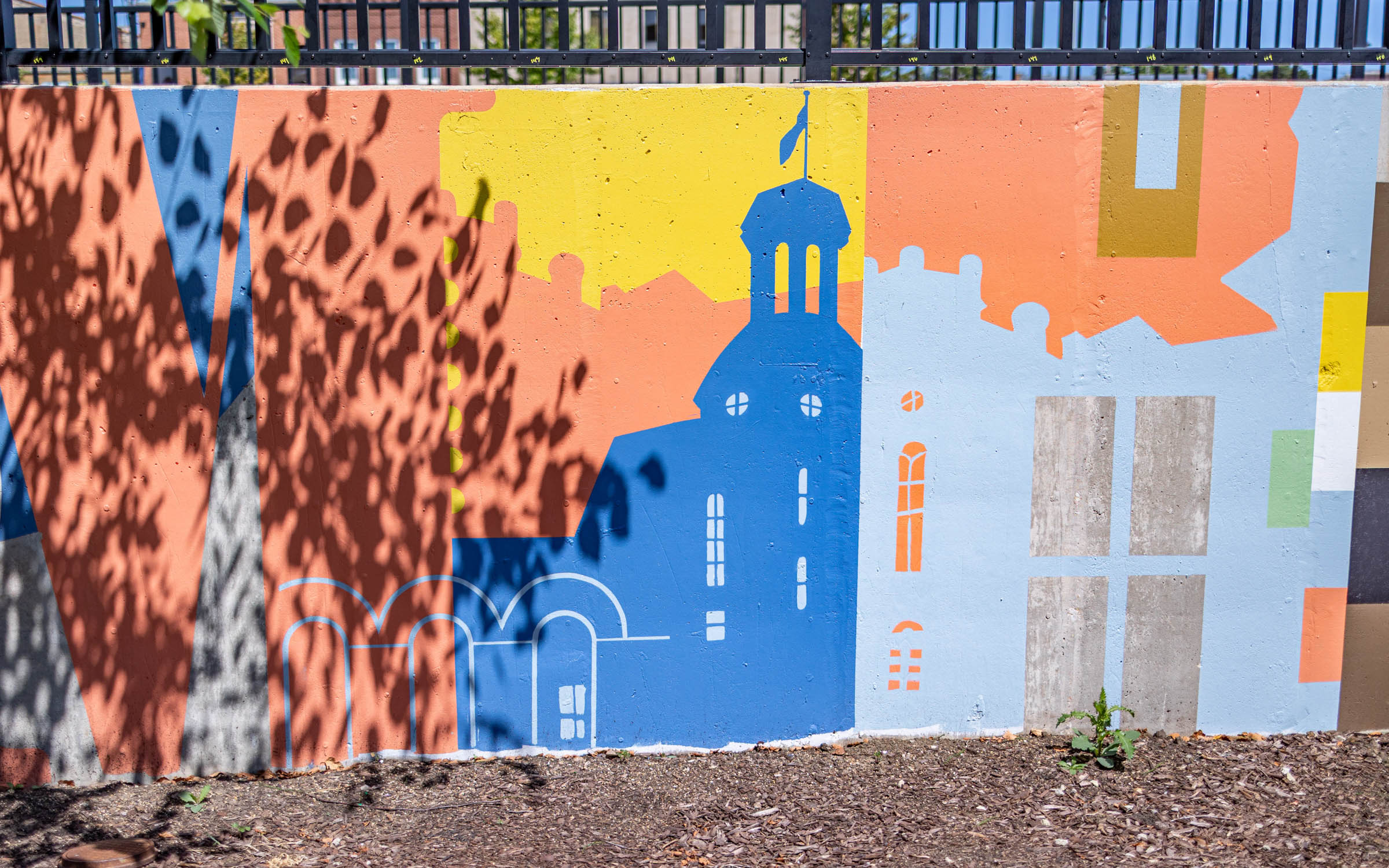 A painting on a wall that depicts Blanchard Hall, a building on Wheaton College's campus.