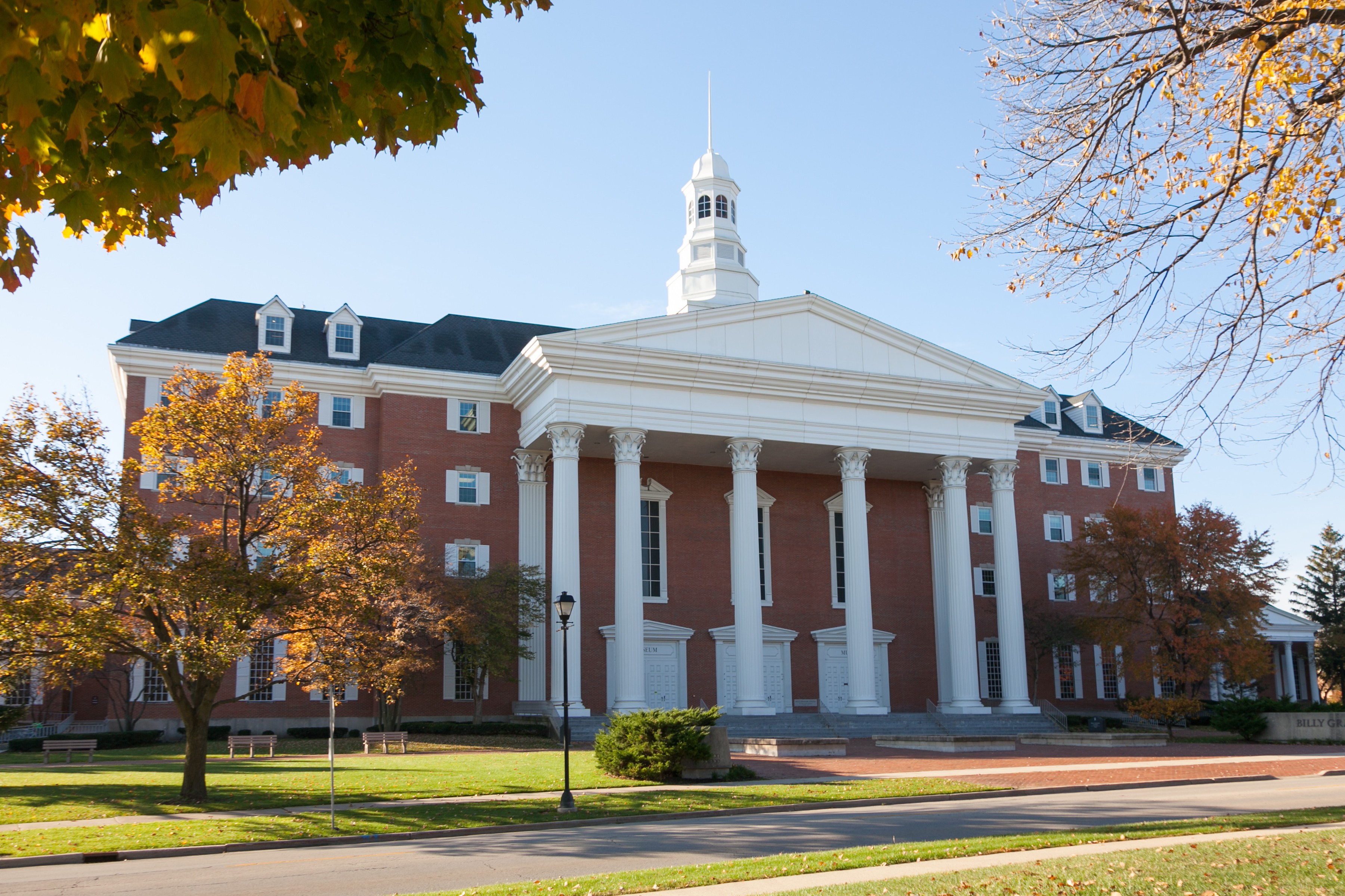 A brick building with white columns