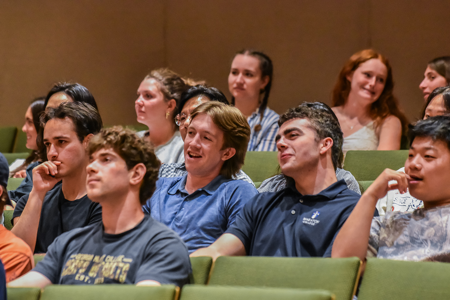students sitting in audience listening to presentation