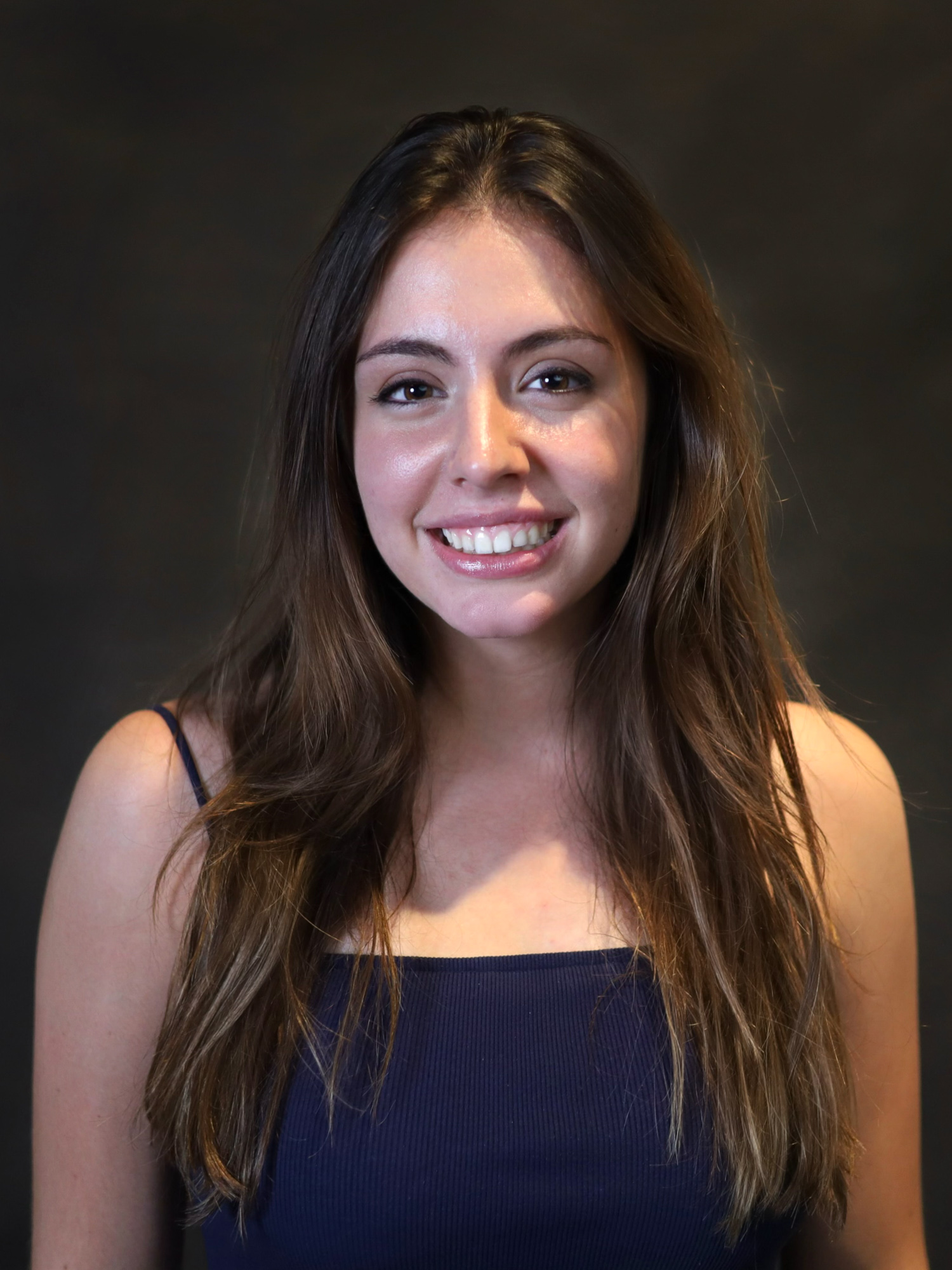 A brunette young woman smiles