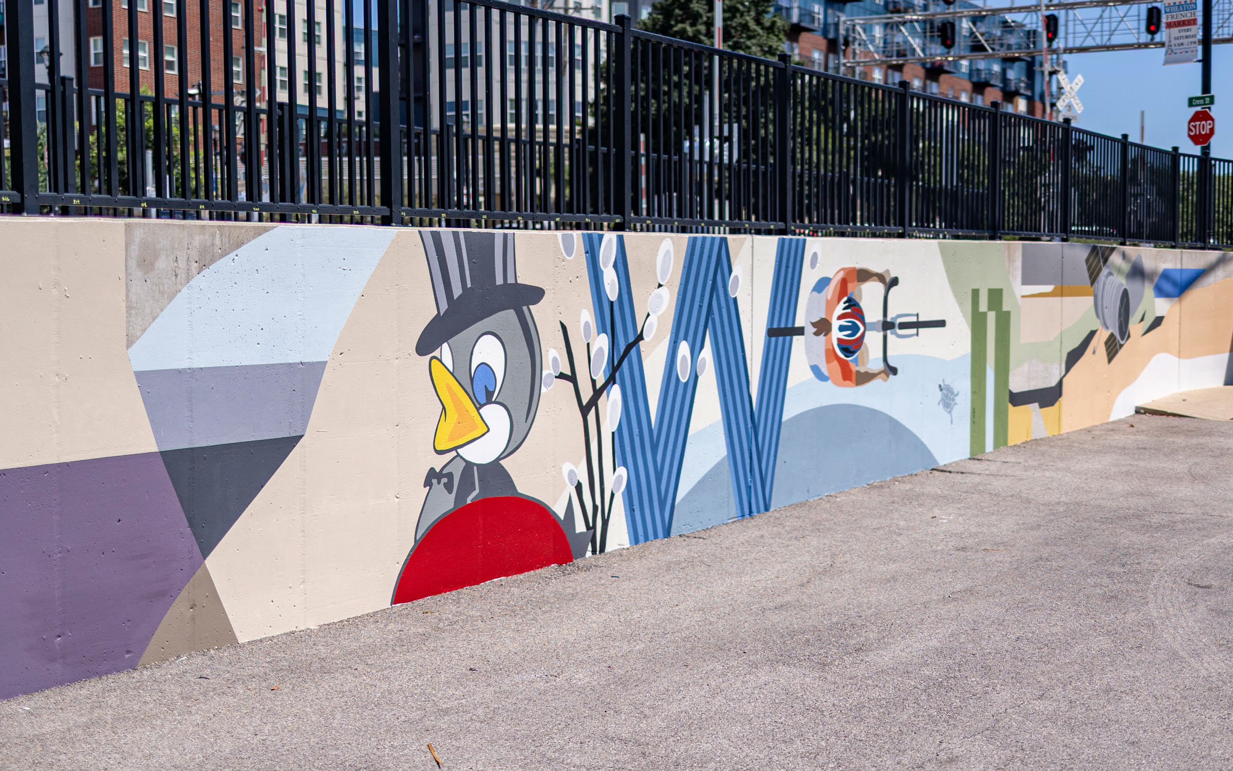A painting on a wall that includes a large cartoon bird.