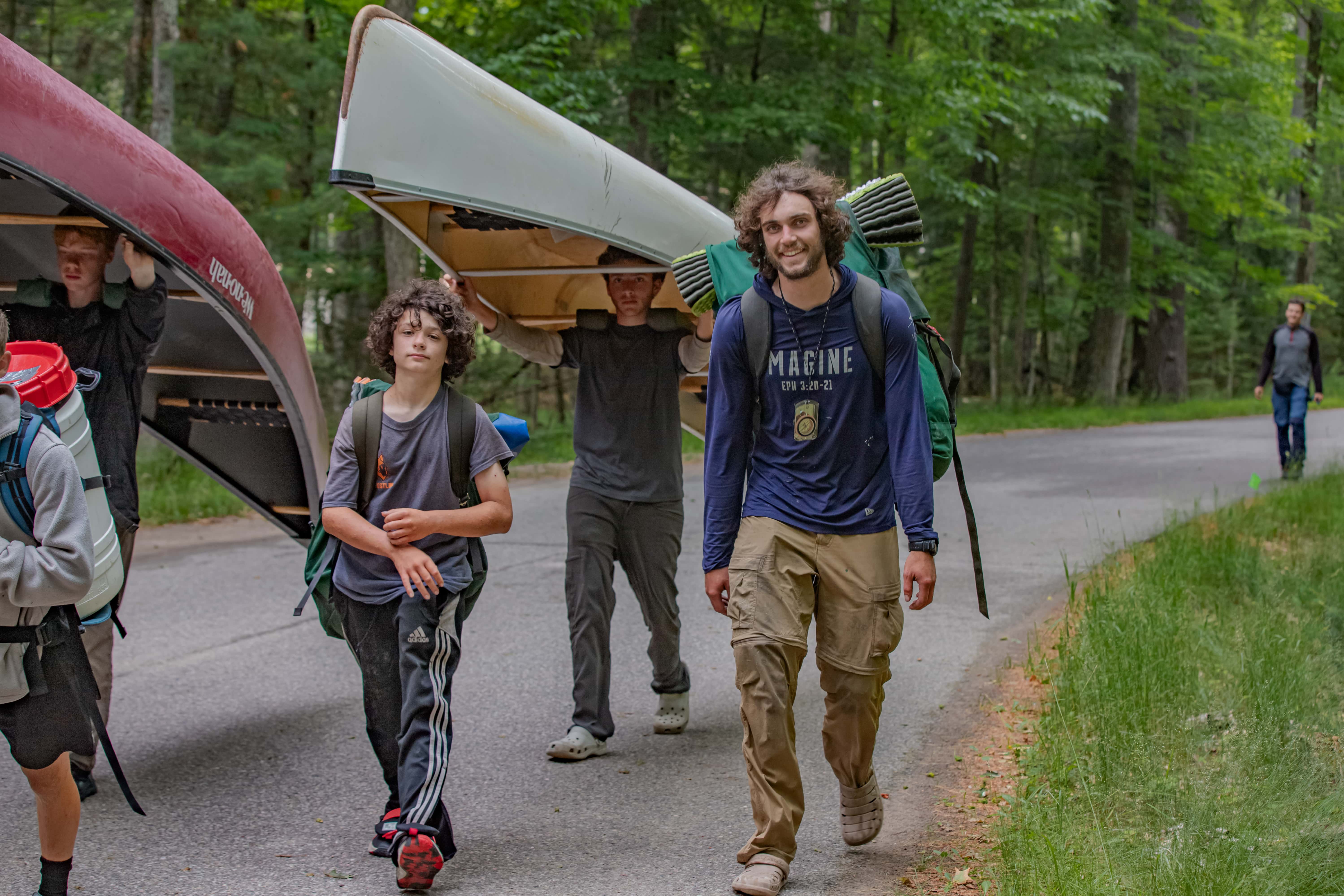 Boys walking with canoes