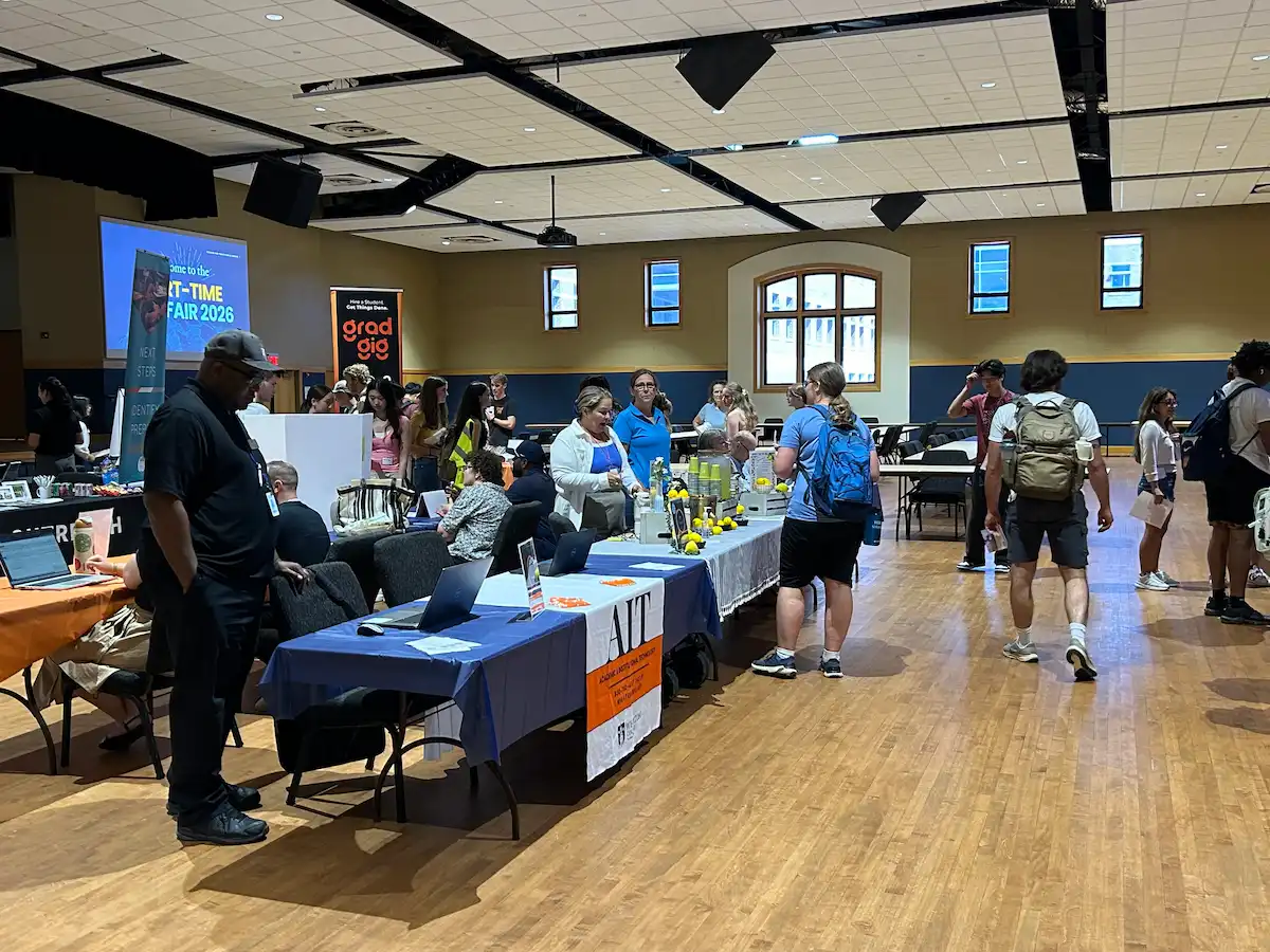 Job fair with attendees visiting vendor tables