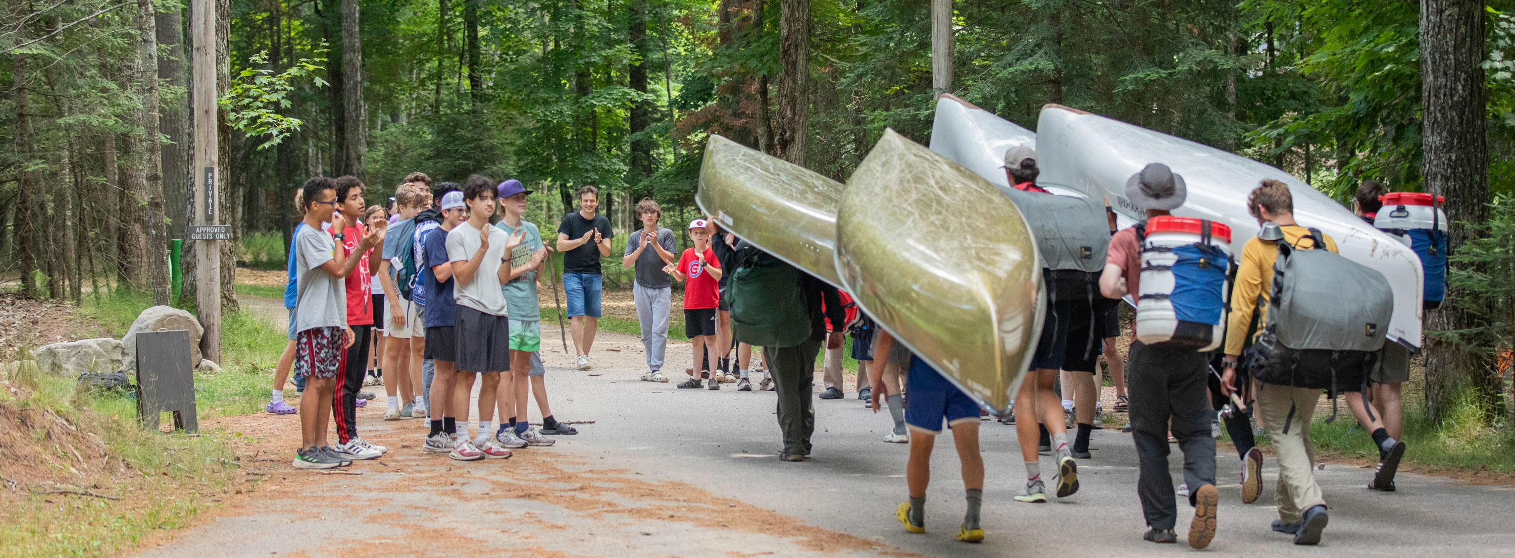 HoneyRock Students Walking with Canoes