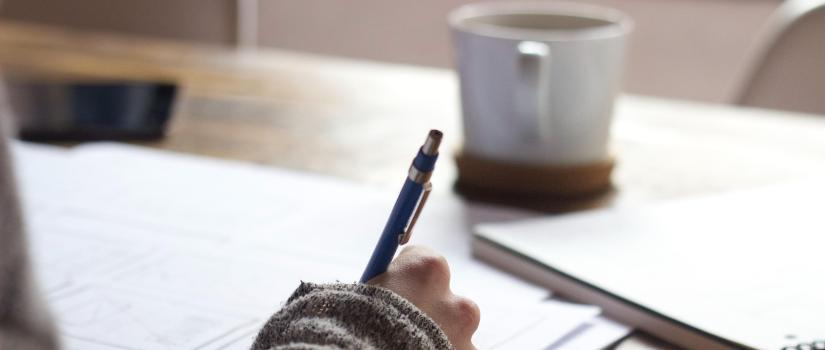 Writing with coffee cup in background 825 x 350 Writing with coffee cup in background 825 x 350