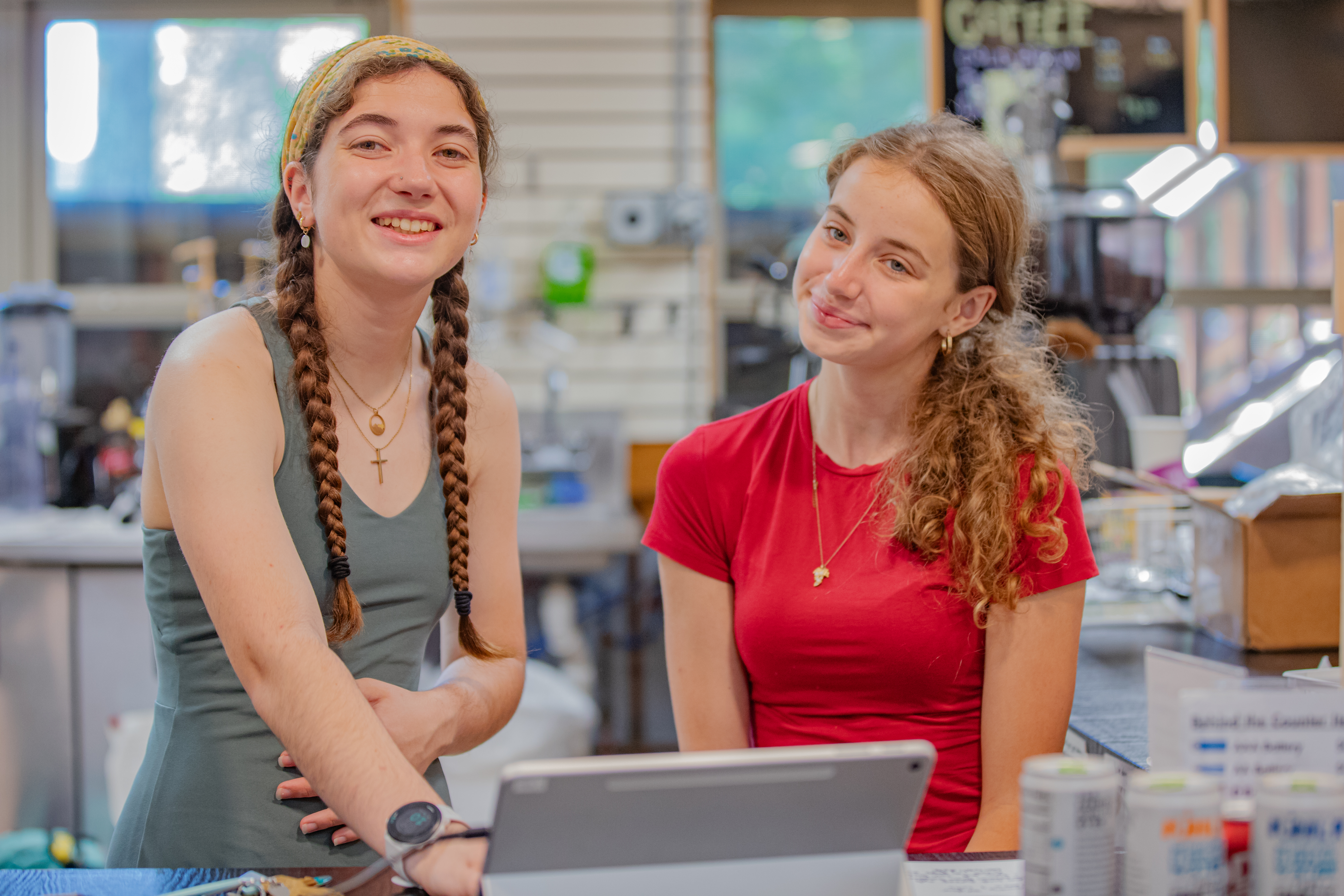 Two girls working in the camp store