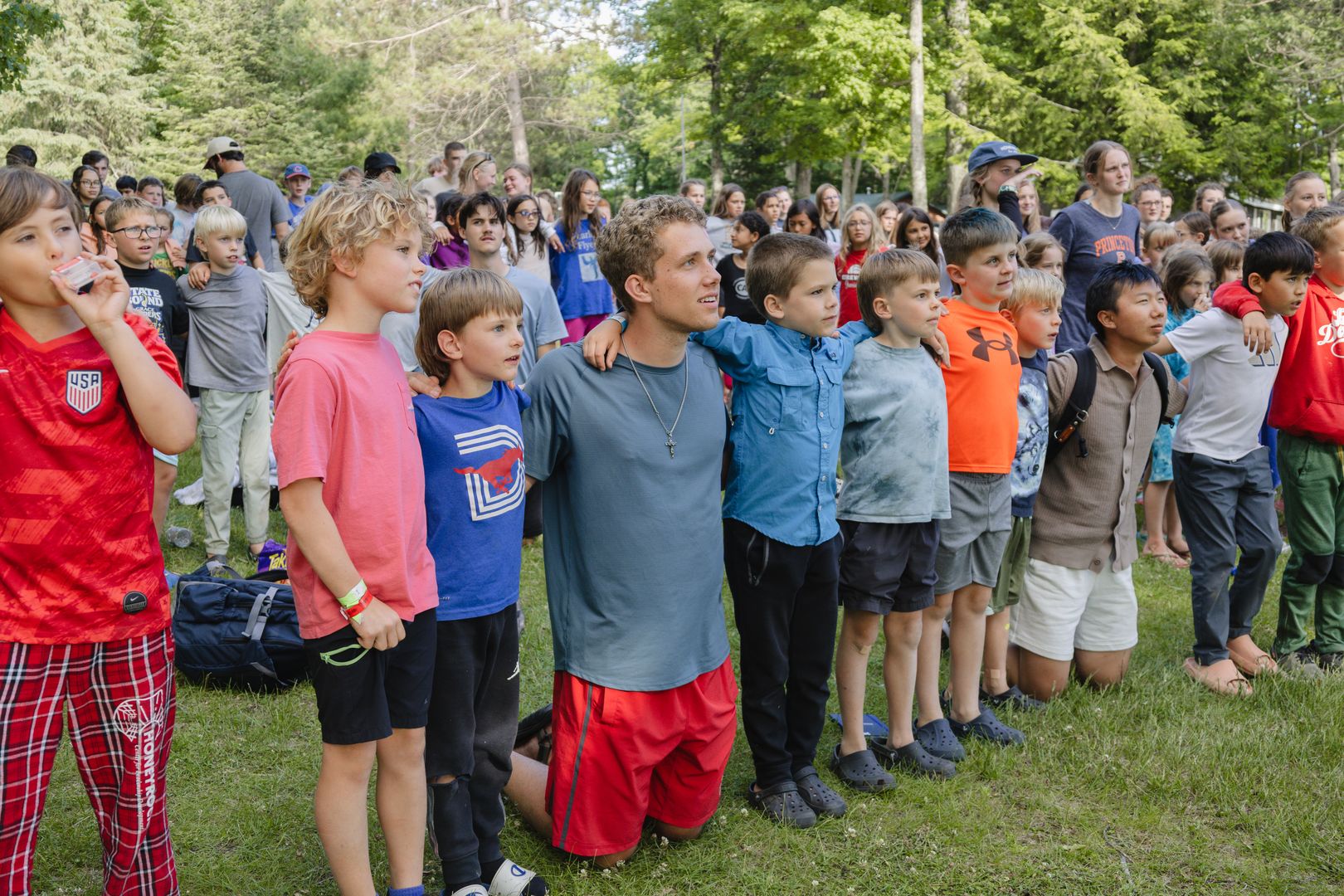 A line of young boys with their cabin leader 