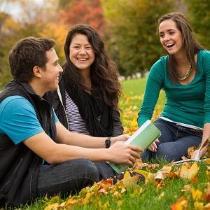 Students talking on Blanchard lawn in autumn