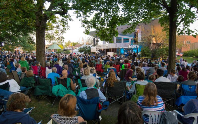 Shakespeare performance in a park in front of a large audience