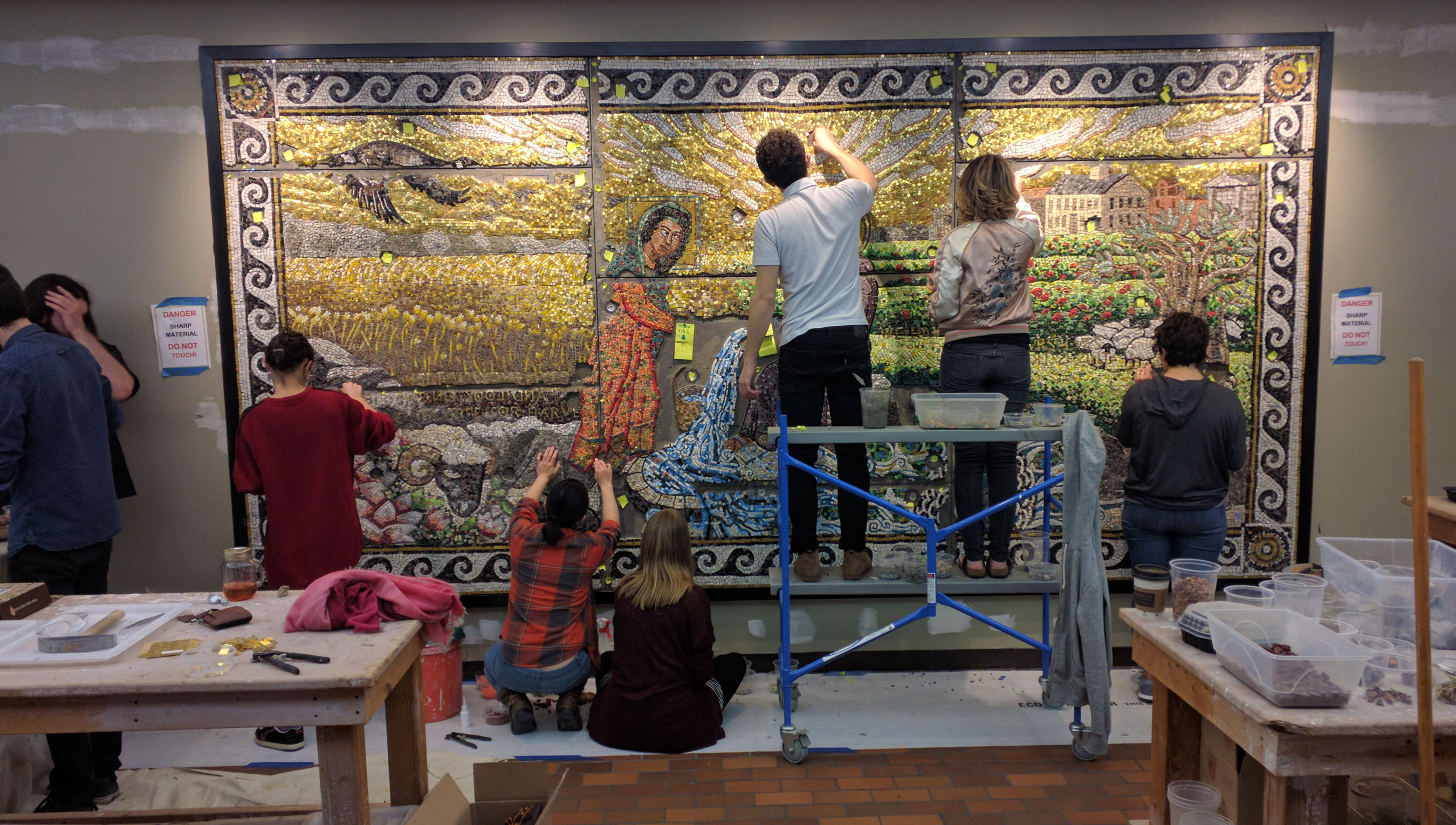 People working on a mural in the BGC