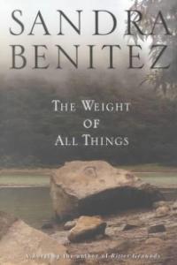 The cover of the book The Weight of All Things by Sandra Benítez, showing a rock over a river surrounded by trees