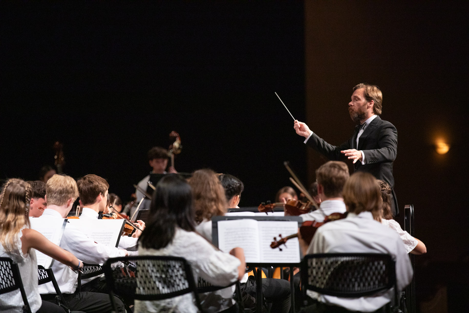 Director conducts a children's orchestra