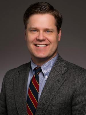 A white man smiles