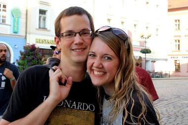 Michal and spouse smiling in a city street
