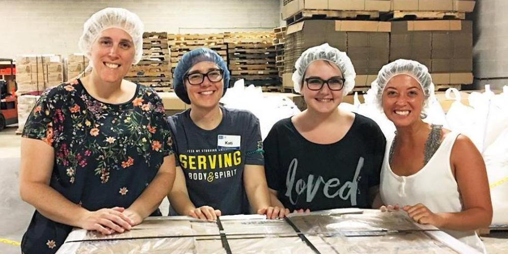 Students volunteering at Feed My Starving Children