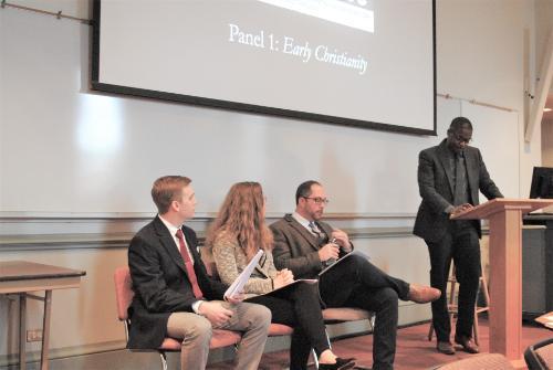 Group of students presenting research at a theology and Christian history conference