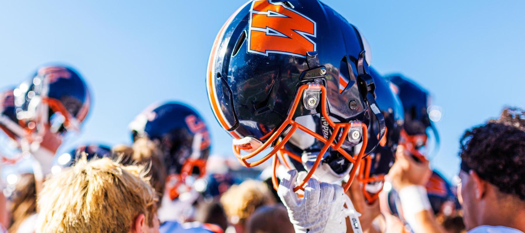 holding-football-helmet-2025