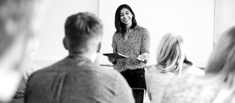 Woman teaching graduate students