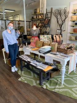 student employee standing next to shop display