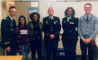 3 Uniformed Services personnel in uniform along with 3 students standing