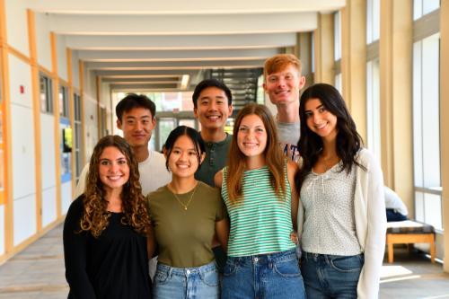 7 students posing in lobby