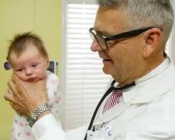 Doctor cradling a baby