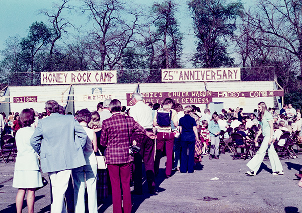 A crowd gathers at an outdoor event celebrating Honey Rock Camp 25th Anniversary