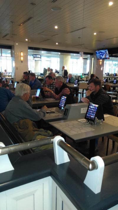 Customers at an iPad restaurant in an airport terminal