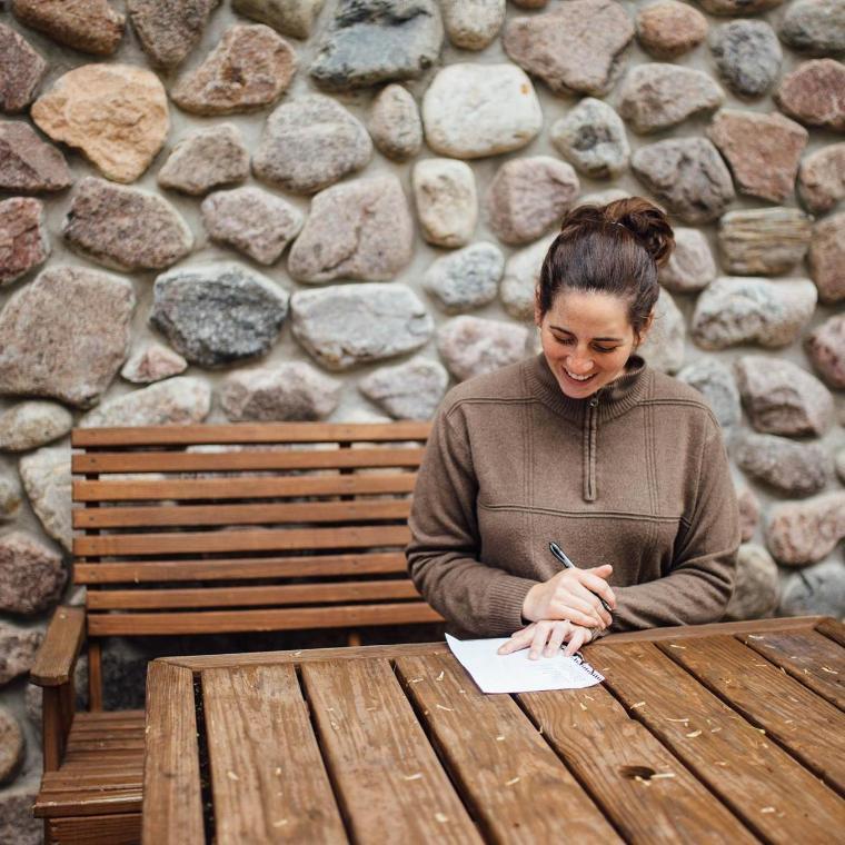woman writing at honeyrock