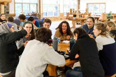 students talking around table at honeyrock