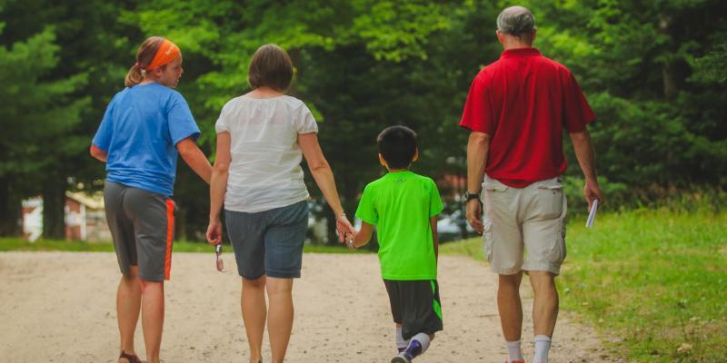 camper family walks down the road at honeyrock