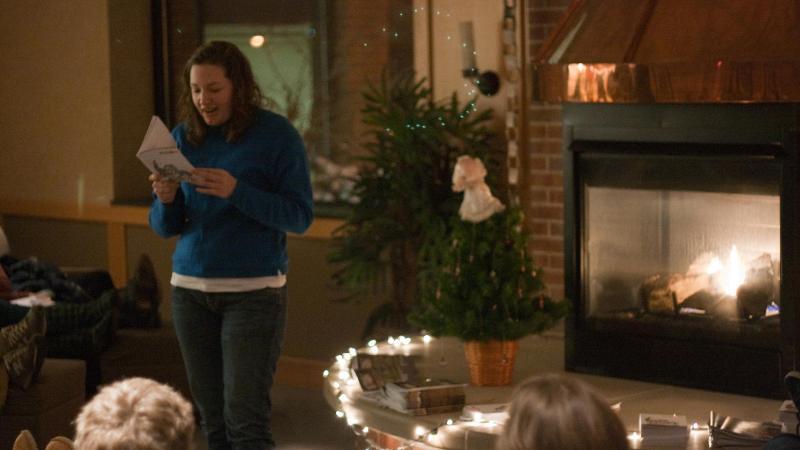 Student reading poetry in Fireside Room