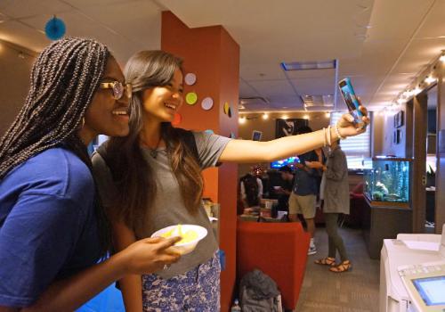 Students in OMD Office taking selfies