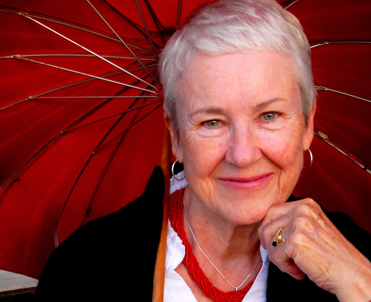 Luci Shaw holding a red umbrella