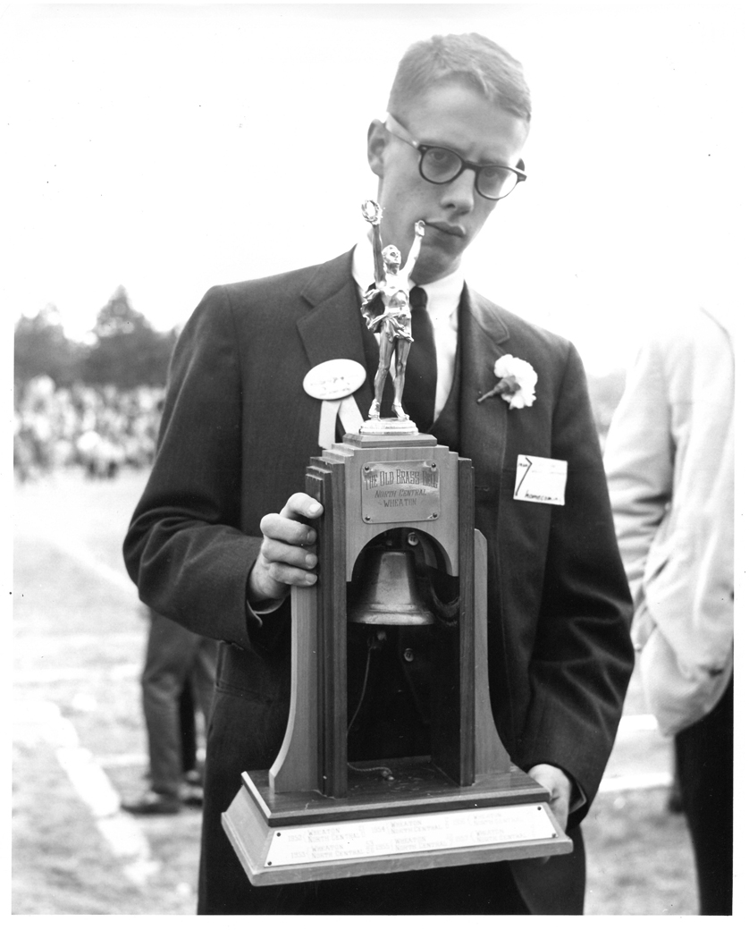 David G. Robb ’62 holding the Little Brass Bell.