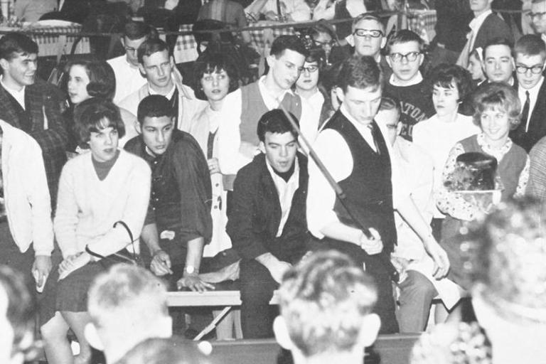 Wheaton College IL students gather to watch the bumper pool playoffs at the 1964 Campus Fair.