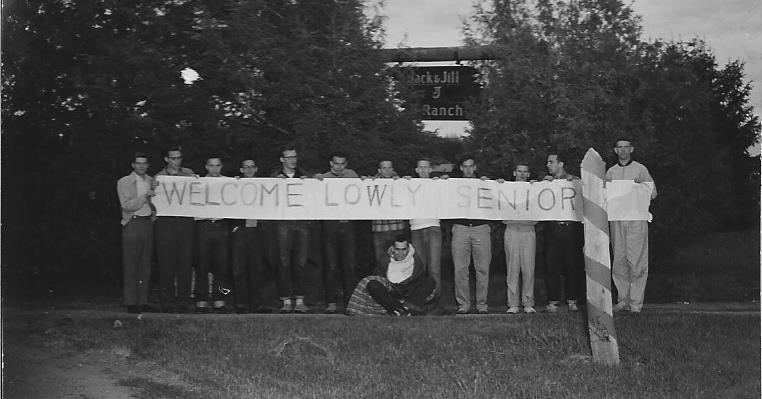 Juniors holding the welcome banner