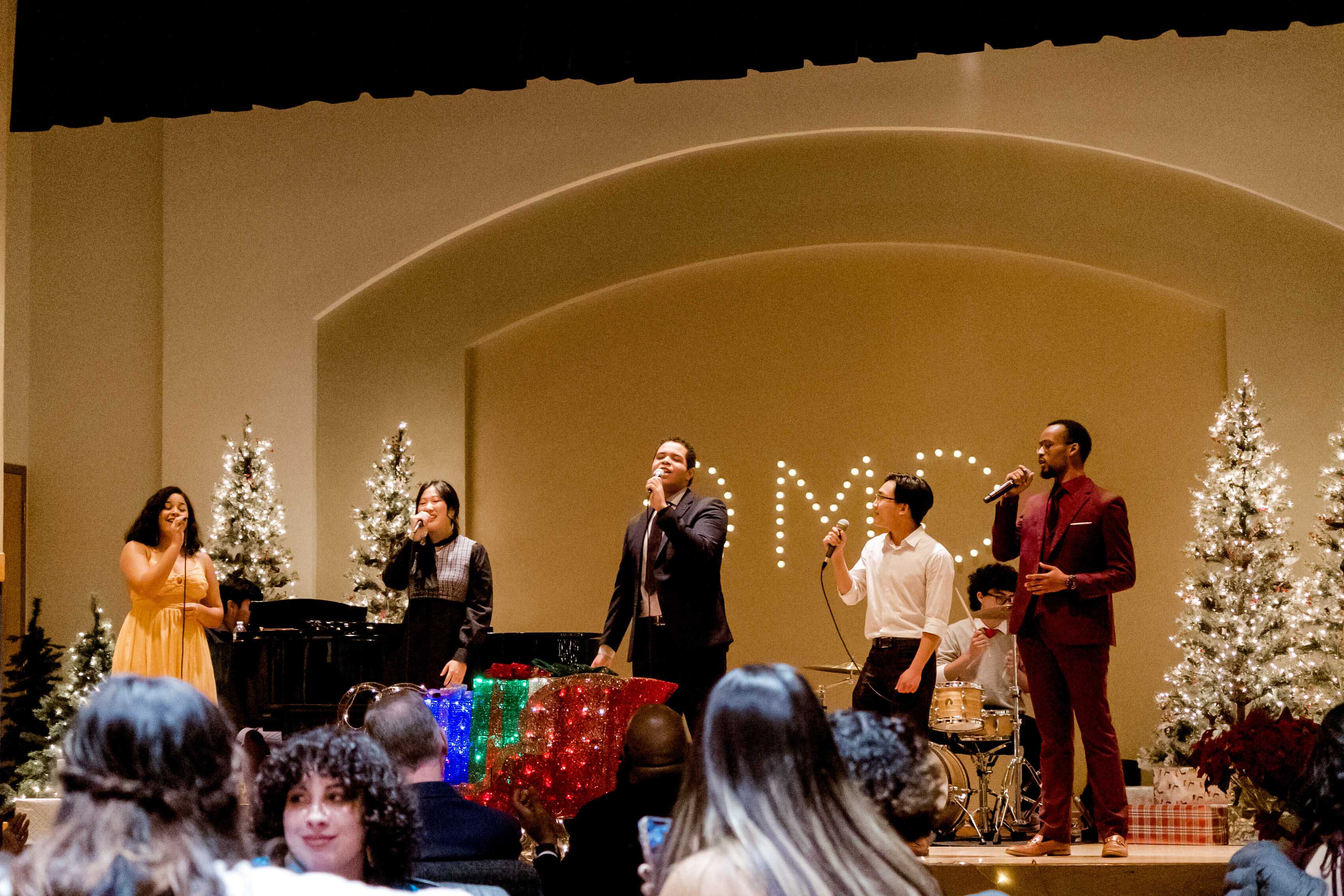 Student leaders perform Christmas songs at OMD gathering