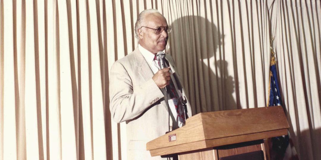 Rev. C. Herbert Oliver Speaking at Podium