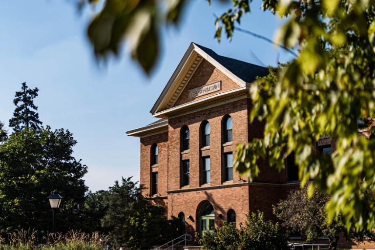 Adams Hall framed by trees on Wheaton College campus