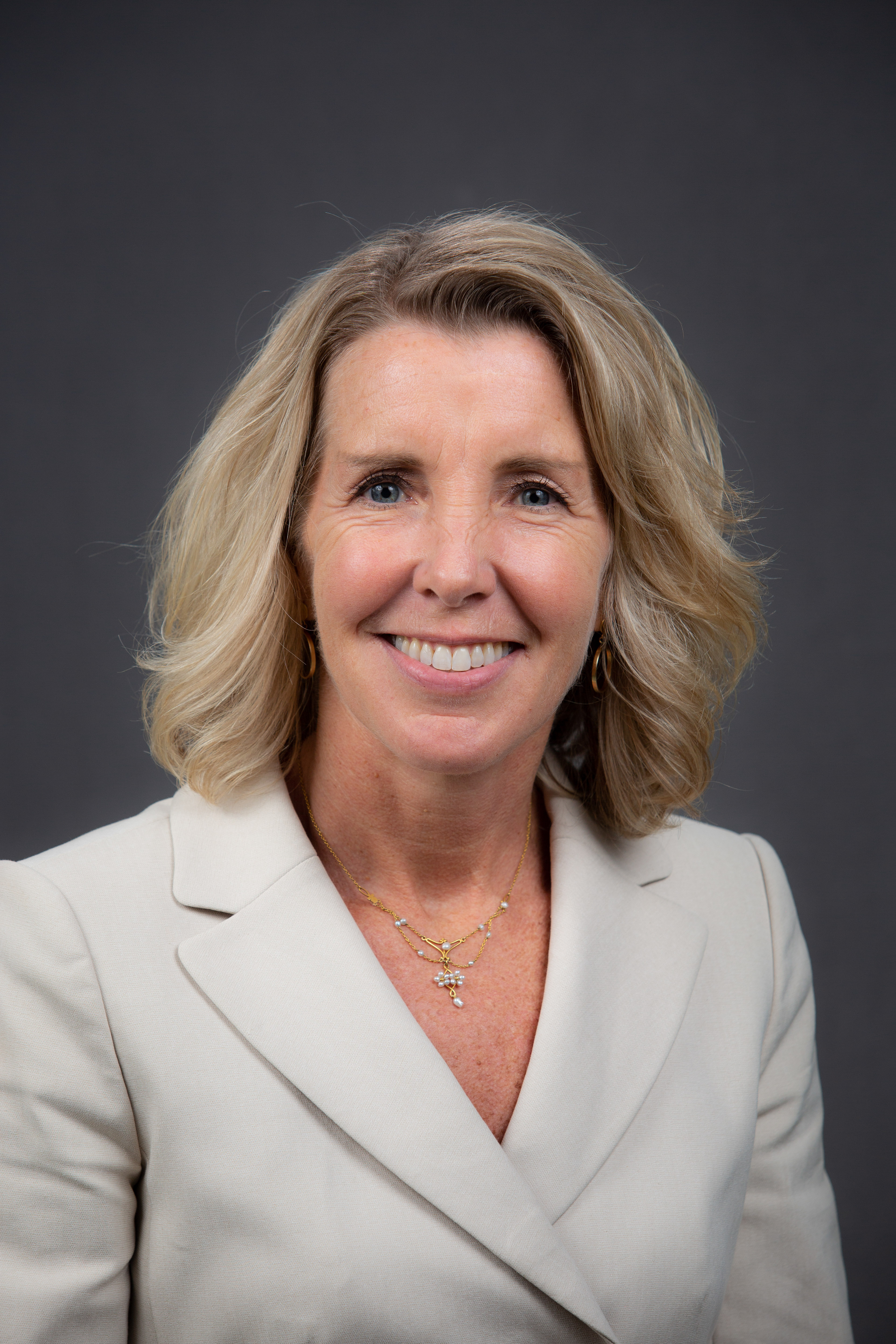 Headshot of Lisa Beamer in white blazer