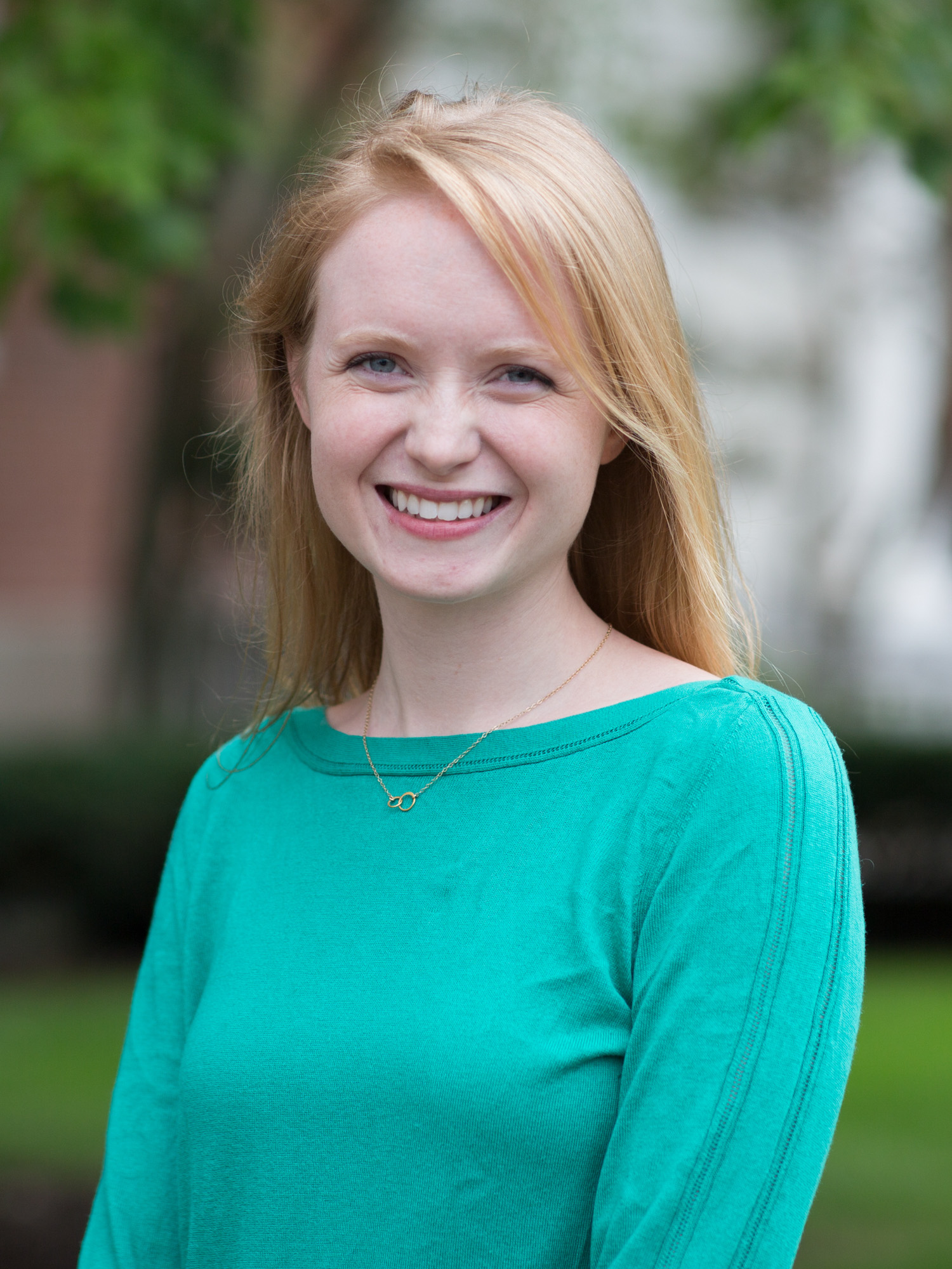 A white woman with strawberry blonde hair smiles
