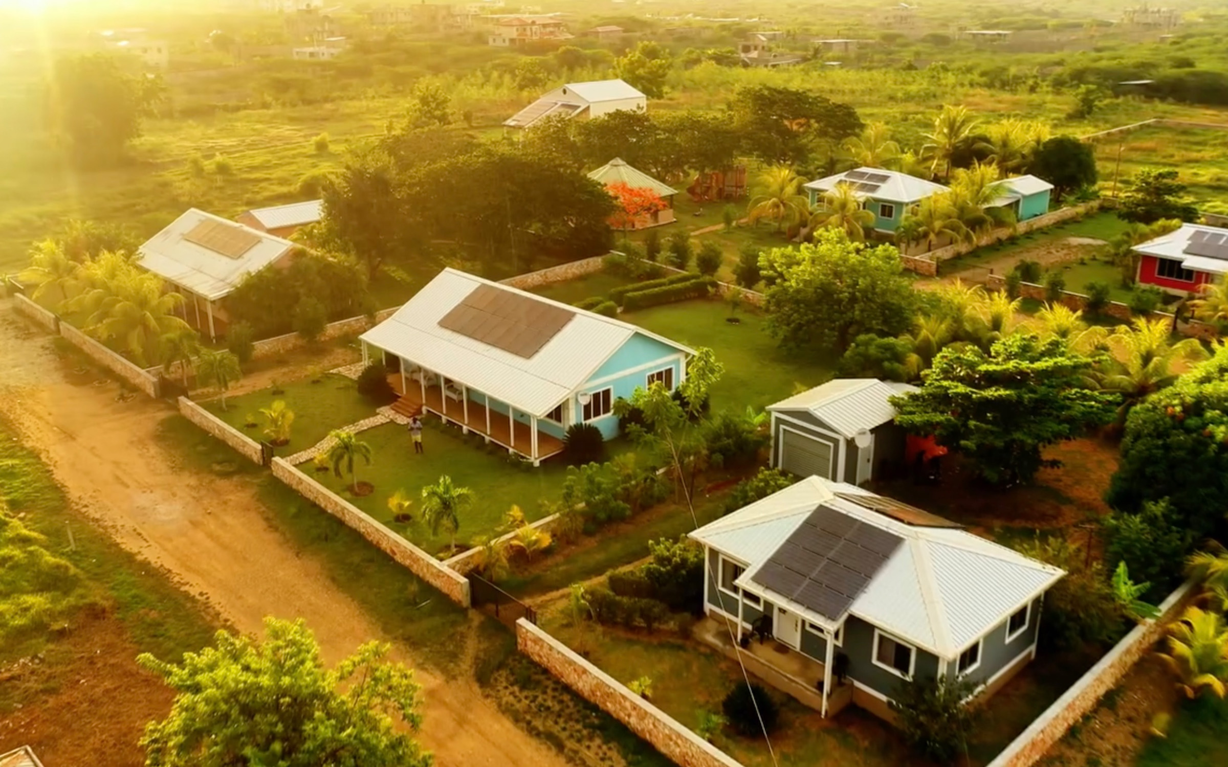 A green landscape with a few houses in view