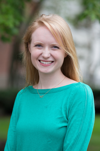 A white woman with strawberry blonde hair smiles