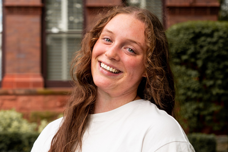 A young white woman smiles